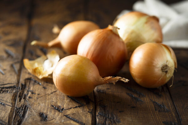 Pukekohe Long Keeper Onions on a country rustic table