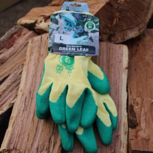 Green Leaf Gardening gloves on a wood stack
