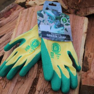 Green Gardening gloves on a wooden stack